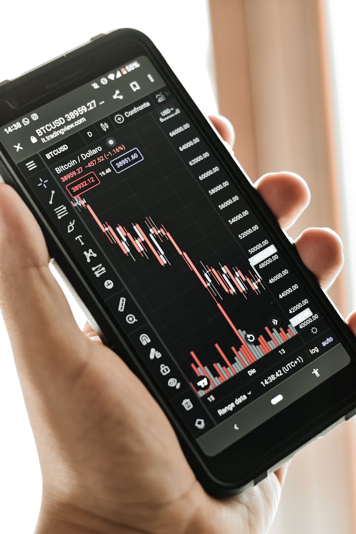 Close-up of a smartphone showing a Bitcoin price chart, indicating market trends.